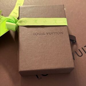 Louis Vuitton brown box with neon green ribbon